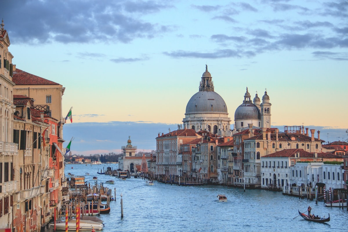 Quiet Venice canal in early morning light with reflections on still water