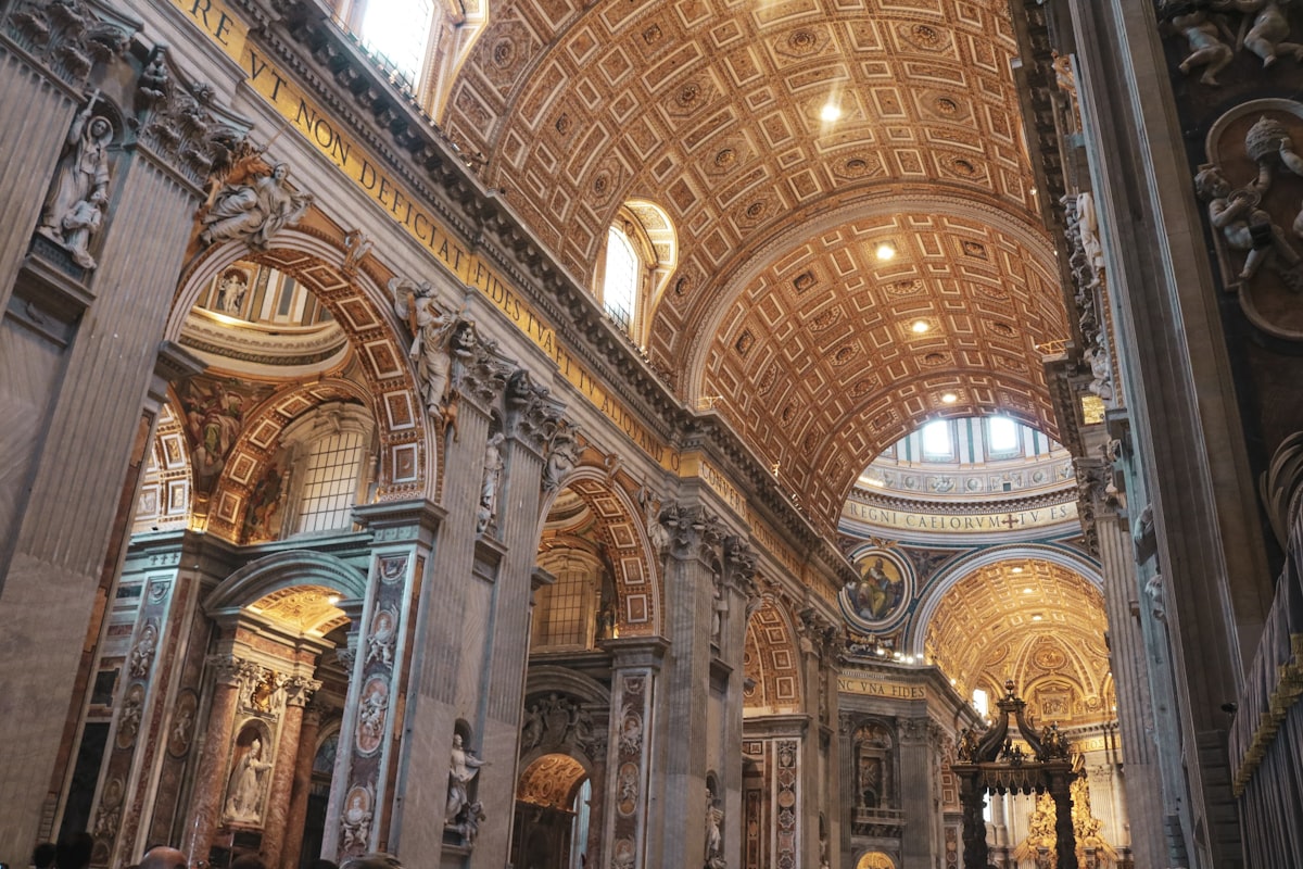 Ornate interior of a Venetian church with painted ceiling and marble columns bathed in natural light