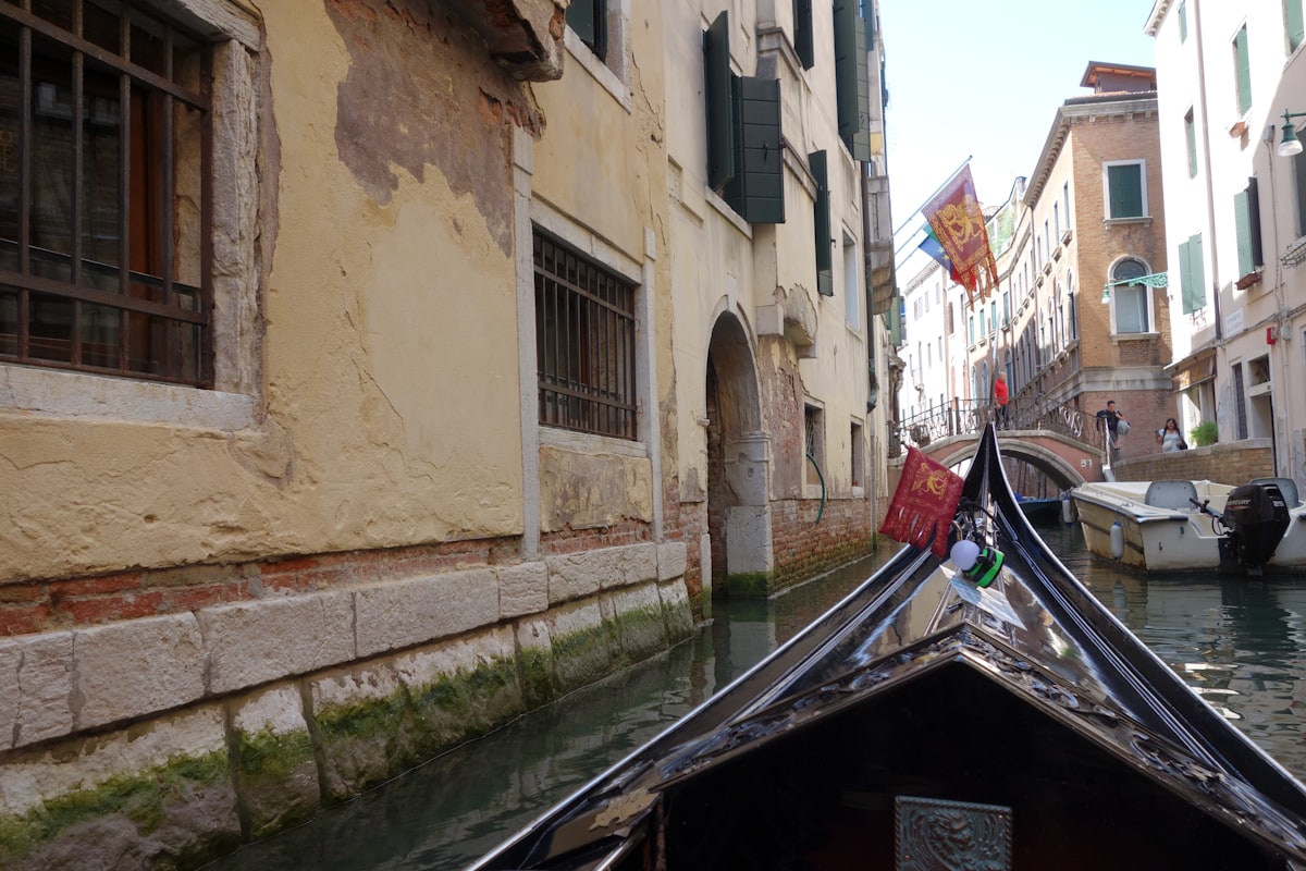 Passengers standing in a traghetto gondola crossing the Grand Canal in Venice